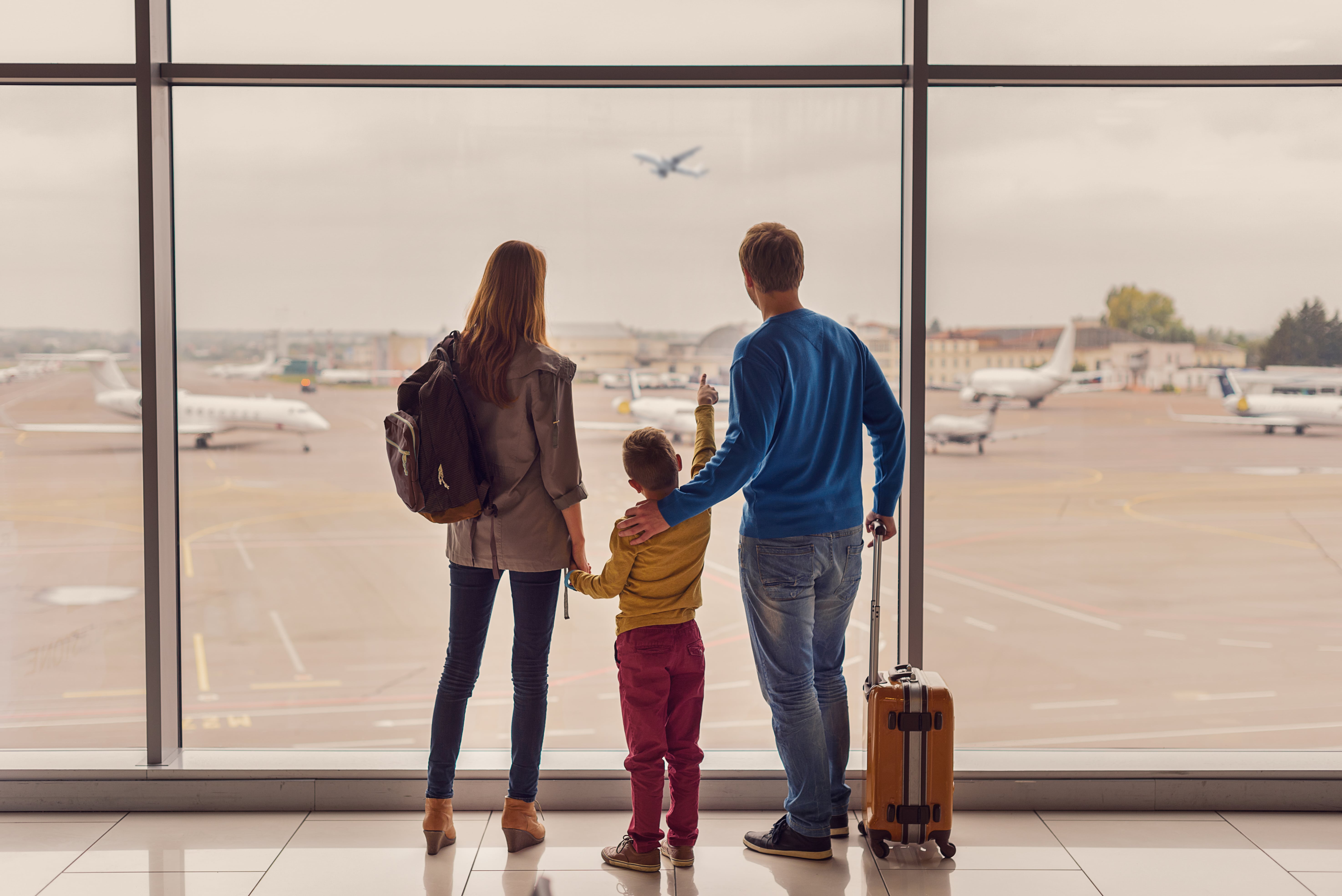 Casal de adultos e criança no aeroporto